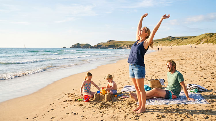 Happy couple stretching on a sunny beach